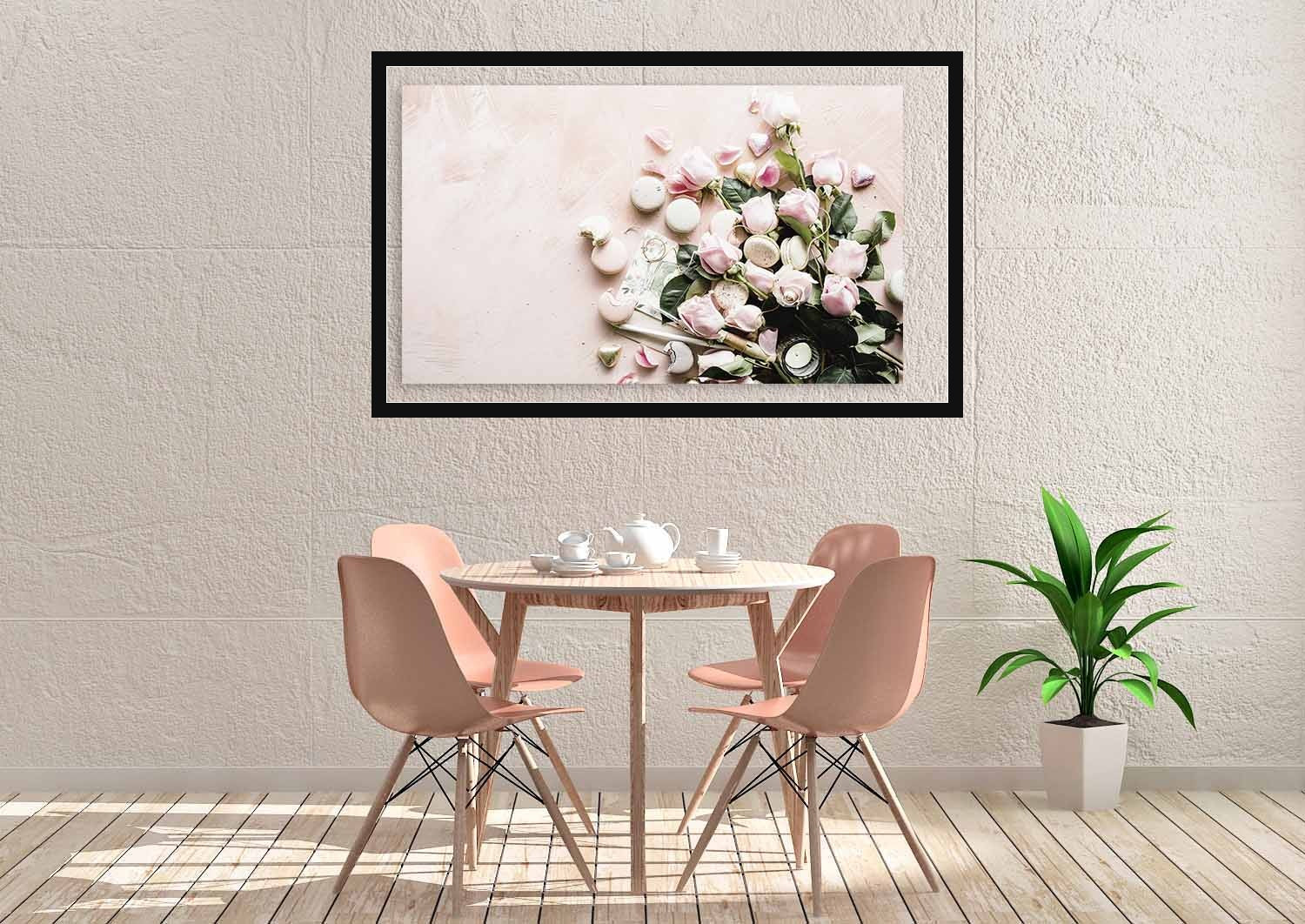 Eetkamer met grote botanische bloemenprint met strakke zwarte lijst als wanddecoratie boven een ronde eettafel met roze stoelen, uit de Botanical Stories-collectie van Wandkraft, voor een stijlvol interieur.