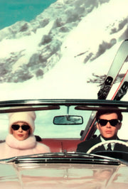 Wandkraft Wanddekoration: stilvolles Paar mit Sonnenbrillen fährt in einem roten Cabrio mit Skiern durch verschneite Berge, Wanddekoration mit Retro-Stimmung. Für ein stilvolles Interieur
